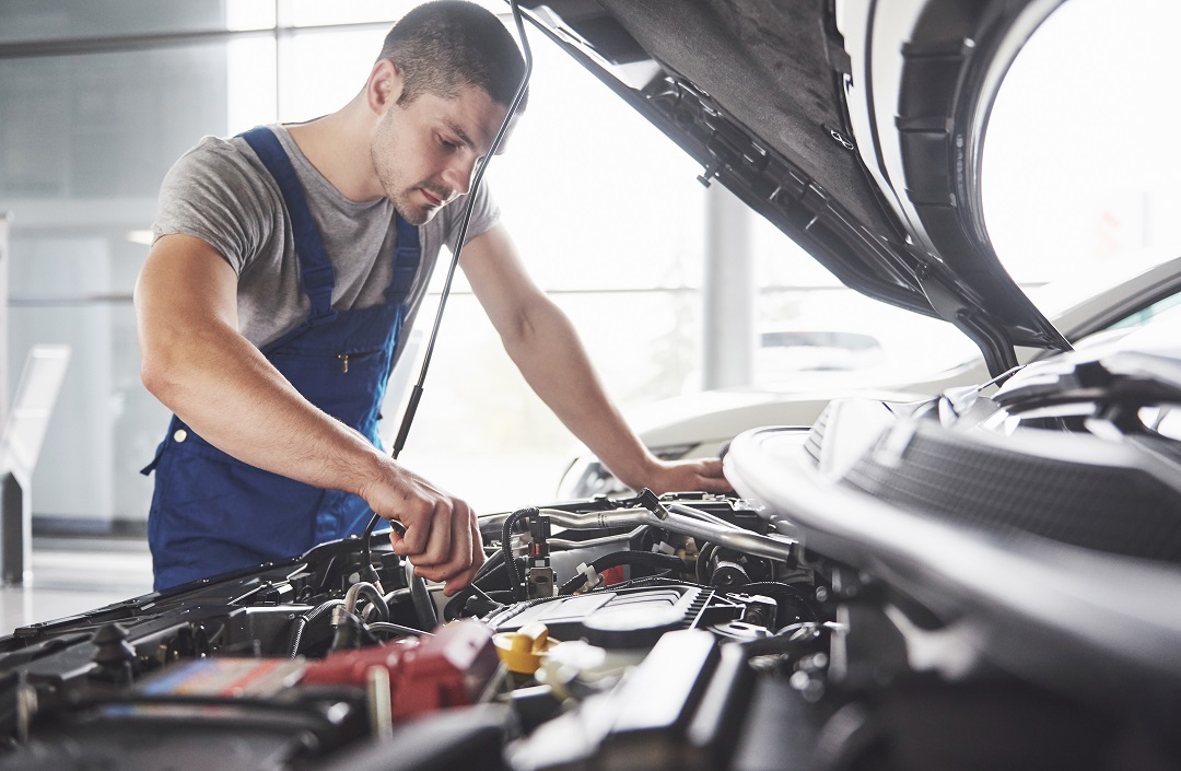 Auto mechanic working in garage. Repair service